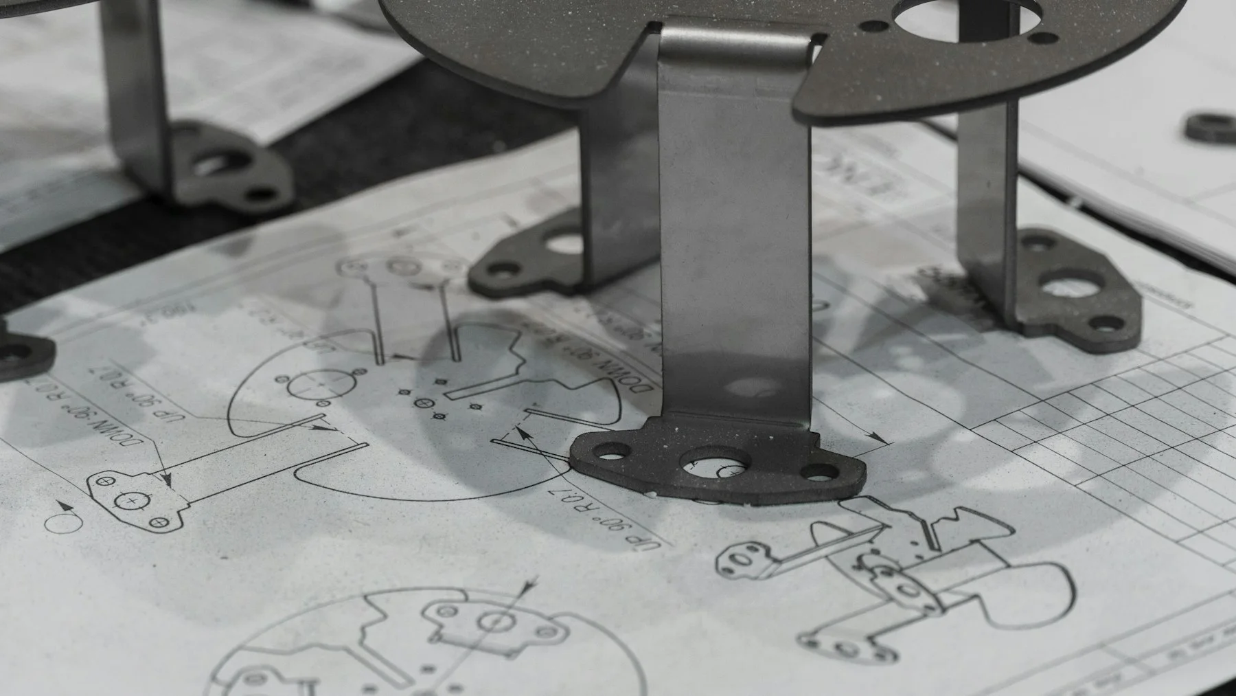 Custom metal components reviewed against technical drawings